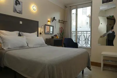 Un ou plusieurs lits dans un hébergement de l'établissement Hotel Novex Paris
