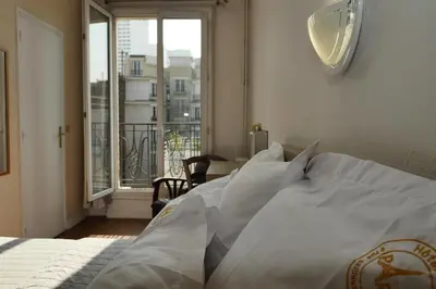 Un ou plusieurs lits dans un hébergement de l'établissement Hotel Novex Paris