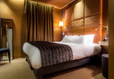 Un ou plusieurs lits dans un hébergement de l'établissement Hotel Armoni Paris