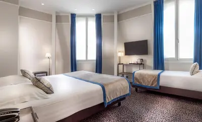 Un ou plusieurs lits dans un hébergement de l'établissement Hôtel Du Bois Champs-Elysées