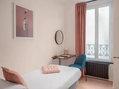 Un ou plusieurs lits dans un hébergement de l'établissement Hôtel Biskui