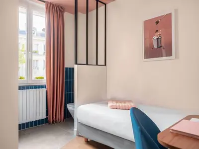 Un ou plusieurs lits dans un hébergement de l'établissement Hôtel Biskui