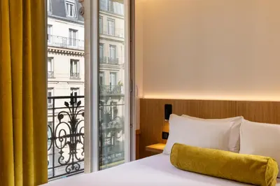 Un ou plusieurs lits dans un hébergement de l'établissement Hôtel WYLD Saint Germain