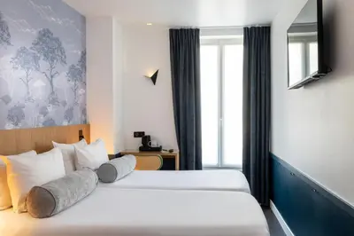 Un ou plusieurs lits dans un hébergement de l'établissement Hôtel WYLD Saint Germain