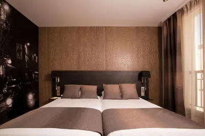Un ou plusieurs lits dans un hébergement de l'établissement Hôtel Eden Opéra