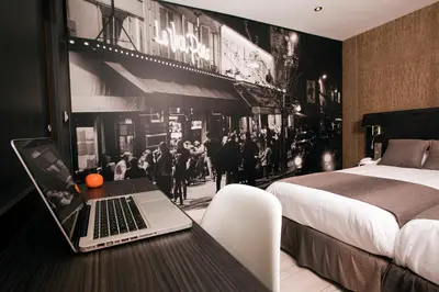 Un ou plusieurs lits dans un hébergement de l'établissement Hôtel Eden Opéra