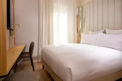 Un ou plusieurs lits dans un hébergement de l'établissement Hôtel Beige
