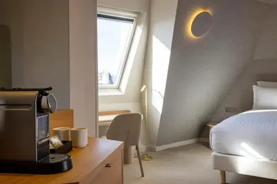 Un ou plusieurs lits dans un hébergement de l'établissement Hôtel Beige