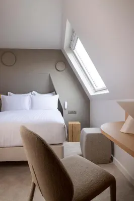 Un ou plusieurs lits dans un hébergement de l'établissement Hôtel Beige