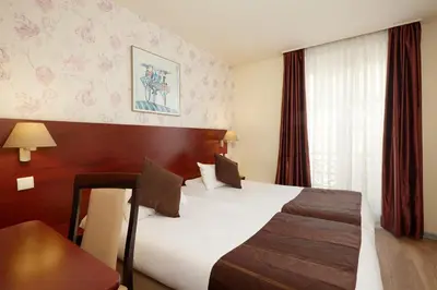 Un ou plusieurs lits dans un hébergement de l'établissement Hôtel Alane