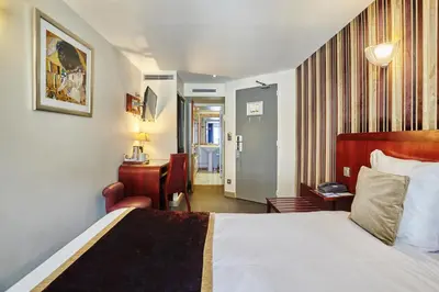 Un ou plusieurs lits dans un hébergement de l'établissement Hotel Opéra d'Antin
