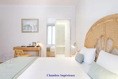 Un ou plusieurs lits dans un hébergement de l'établissement Hotel Boileau