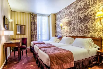 Un ou plusieurs lits dans un hébergement de l'établissement Hotel Regence Paris