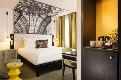 Un ou plusieurs lits dans un hébergement de l'établissement Hôtel Gustave