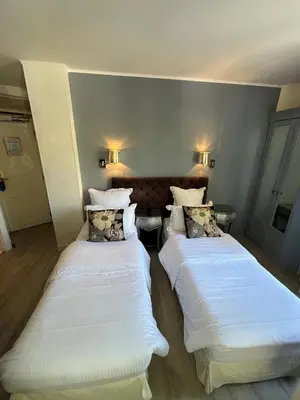 Un ou plusieurs lits dans un hébergement de l'établissement Hotel Cluny Square