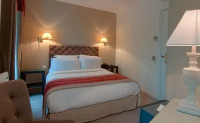 Un ou plusieurs lits dans un hébergement de l'établissement Hotel Cluny Square