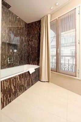 Un ou plusieurs lits dans un hébergement de l'établissement Hôtel Elysées Paris