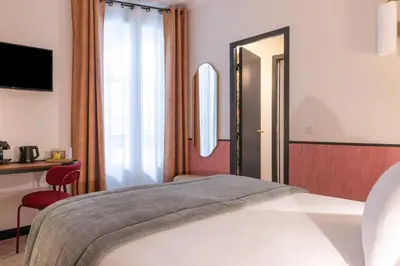 Un ou plusieurs lits dans un hébergement de l'établissement Hôtel Brittany