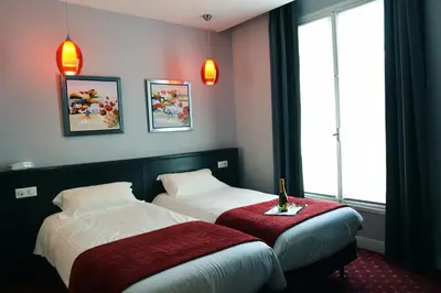 Un ou plusieurs lits dans un hébergement de l'établissement Hotel du Pré