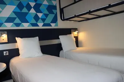 Un ou plusieurs lits dans un hébergement de l'établissement Comfort Hotel Paris Porte d'Ivry