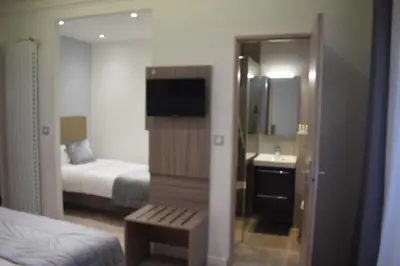 Un ou plusieurs lits dans un hébergement de l'établissement Hotel Puy De Dôme