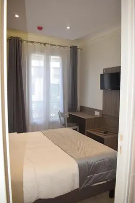 Un ou plusieurs lits dans un hébergement de l'établissement Hotel Puy De Dôme
