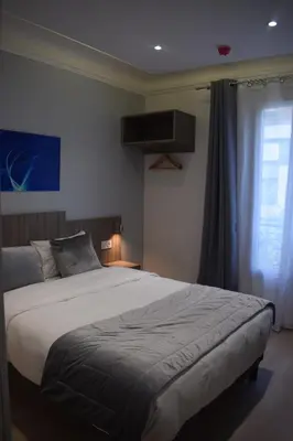 Un ou plusieurs lits dans un hébergement de l'établissement Hotel Puy De Dôme