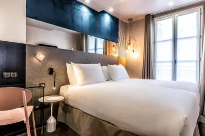 Un ou plusieurs lits dans un hébergement de l'établissement Hotel Duette Paris