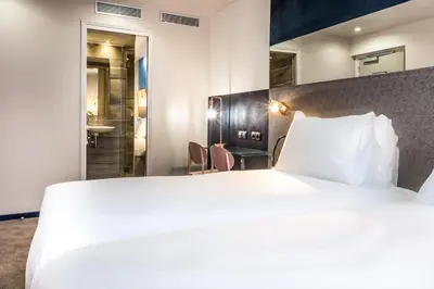 Un ou plusieurs lits dans un hébergement de l'établissement Hotel Duette Paris