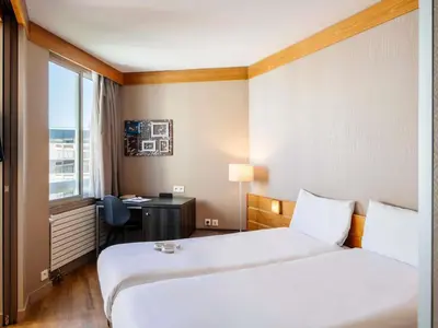 Un ou plusieurs lits dans un hébergement de l'établissement Aparthotel Adagio Paris XV