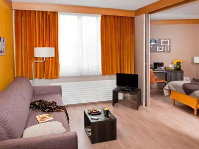 Télévision ou salle de divertissement dans l'établissement Aparthotel Adagio Paris XV