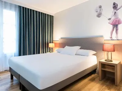Un ou plusieurs lits dans un hébergement de l'établissement Aparthotel Adagio Paris Montmartre