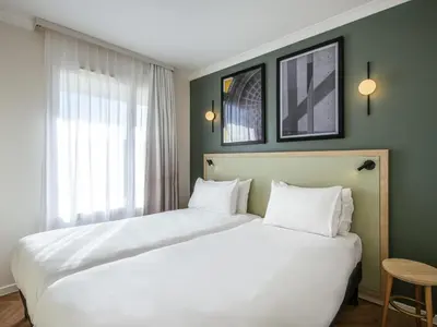 Un ou plusieurs lits dans un hébergement de l'établissement Aparthotel Adagio Paris Buttes Chaumont