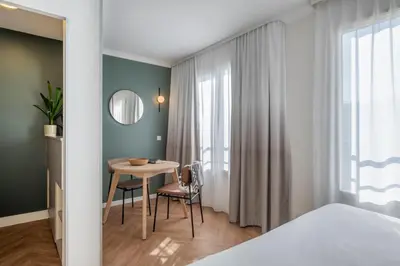 Un ou plusieurs lits dans un hébergement de l'établissement Aparthotel Adagio Paris Buttes Chaumont