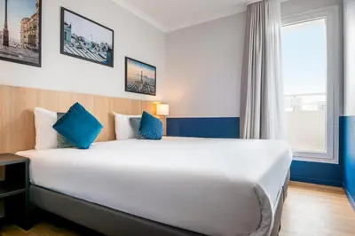 Un ou plusieurs lits dans un hébergement de l'établissement Aparthotel Adagio La Défense Kléber