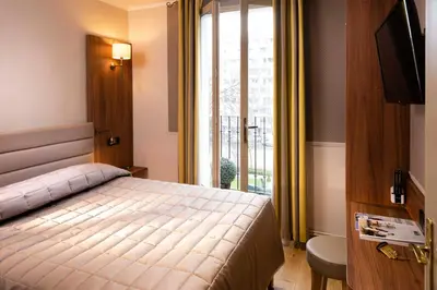 Un ou plusieurs lits dans un hébergement de l'établissement Hôtel de la Tour Eiffel