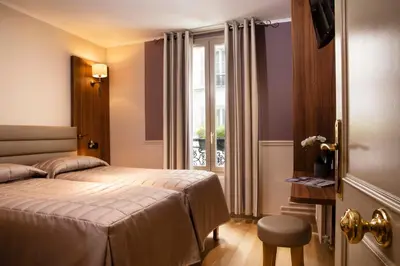 Un ou plusieurs lits dans un hébergement de l'établissement Hôtel de la Tour Eiffel
