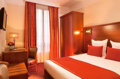 Un ou plusieurs lits dans un hébergement de l'établissement Hotel Terminus Lyon