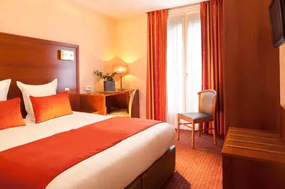 Un ou plusieurs lits dans un hébergement de l'établissement Hotel Terminus Lyon