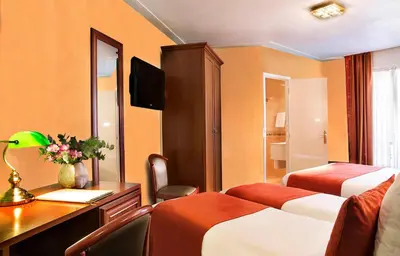 Un ou plusieurs lits dans un hébergement de l'établissement Hotel Terminus Lyon