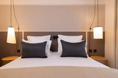 Un ou plusieurs lits dans un hébergement de l'établissement Hôtel Toujours & Spa