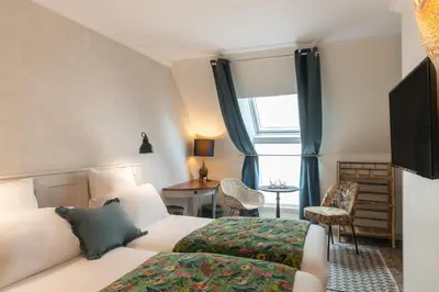Un ou plusieurs lits dans un hébergement de l'établissement Hotel Touraine Opera