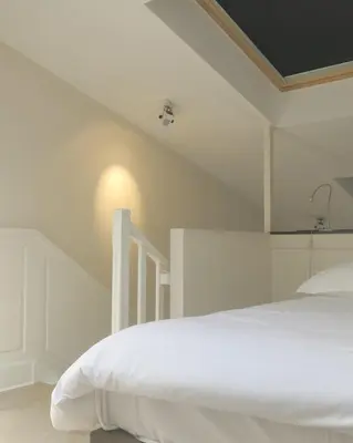 Un ou plusieurs lits dans un hébergement de l'établissement Mini Loft Daval