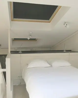 Un ou plusieurs lits dans un hébergement de l'établissement Mini Loft Daval