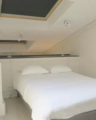 Un ou plusieurs lits dans un hébergement de l'établissement Mini Loft Daval