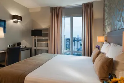 Un ou plusieurs lits dans un hébergement de l'établissement Timhotel Opéra Blanche Fontaine