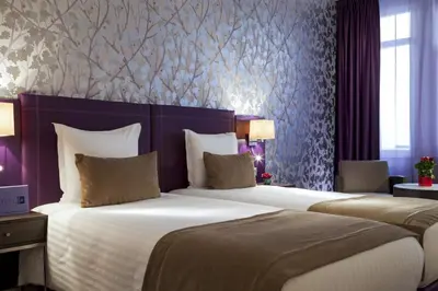 Un ou plusieurs lits dans un hébergement de l'établissement Timhotel Opéra Blanche Fontaine