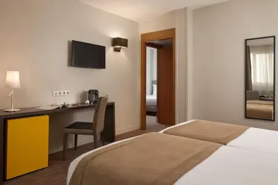 Un ou plusieurs lits dans un hébergement de l'établissement Timhotel Opéra Blanche Fontaine