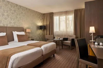 Un ou plusieurs lits dans un hébergement de l'établissement Timhotel Opéra Blanche Fontaine