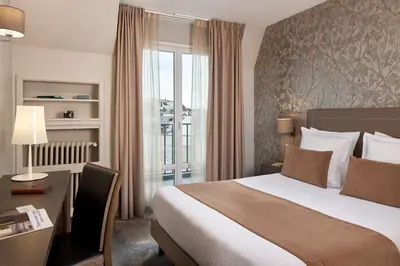 Un ou plusieurs lits dans un hébergement de l'établissement Timhotel Opéra Blanche Fontaine